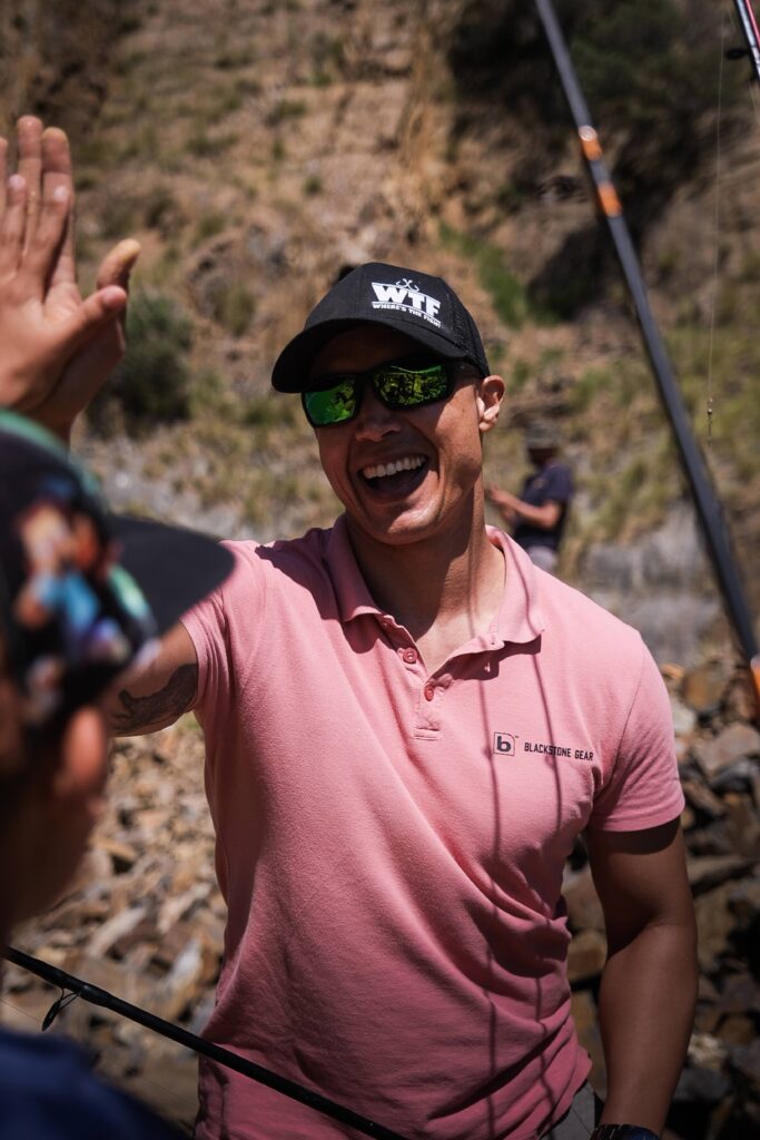 Smiling teacher high-fives a child at Cooper Abbott’s fishing birthday party at Hillcrest Quarry in Cape Town on 14 September 2025